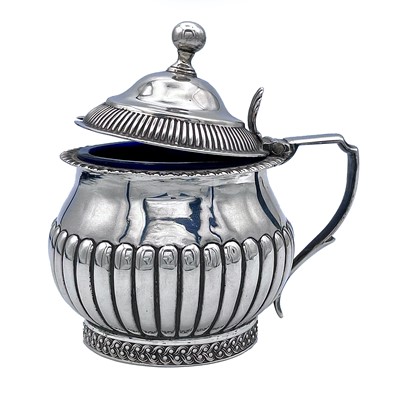 Lot 86 - A George III silver ovoid half fluted hinge...