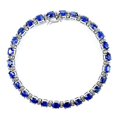 Lot 11 - A modern 18ct white gold sapphire and diamond...