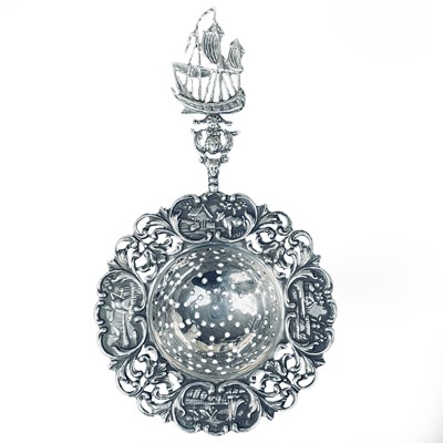 Lot 195 - A Dutch silver tea strainer, repousse...