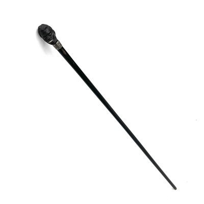 Lot 89 - An ebonised walking stick with a carved top in...