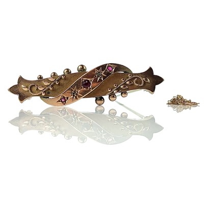 Lot 131 - A 9ct bar brooch set with two chip diamonds...