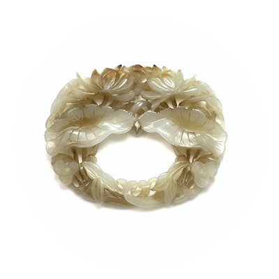 Lot 283 - A Chinese oval jade carving of flowers and...