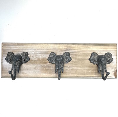 Lot 201 - An elephant head coat rack with three hooks on...