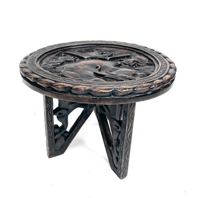 Lot 220 - An African wood carved circular folding table...