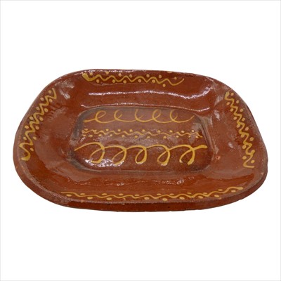 Lot 1314 - An early 19th century slipware baking dish,...