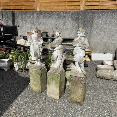 Lot 617 - A set of three reconstituted stone figures...