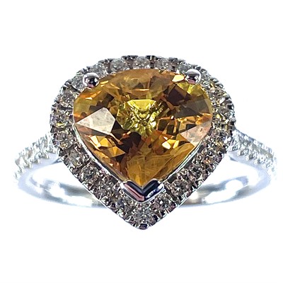 Lot 60 - An 18ct white gold yellow sapphire and diamond...