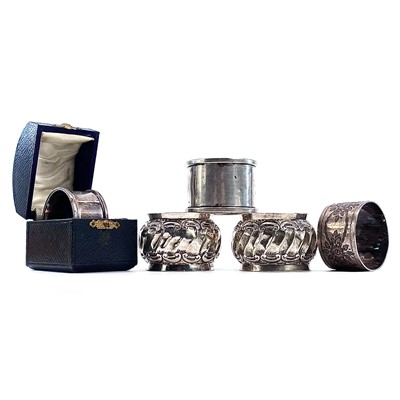 Lot 99 - Four silver hallmarked napkin rings, one cased,...