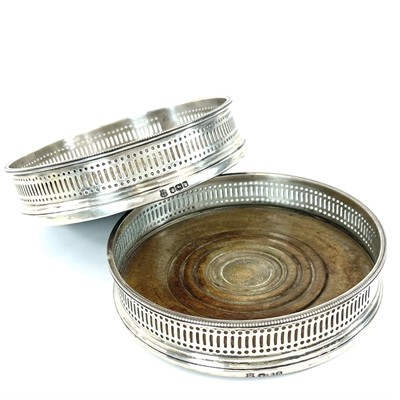 Lot 130 - A pair of George V silver wine coasters by...