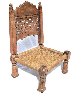 Lot 1014 - An Afghan carved wood low chair, 19th century,...