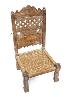 Lot 1015 - An Afghan carved wood low chair, 19th century,...