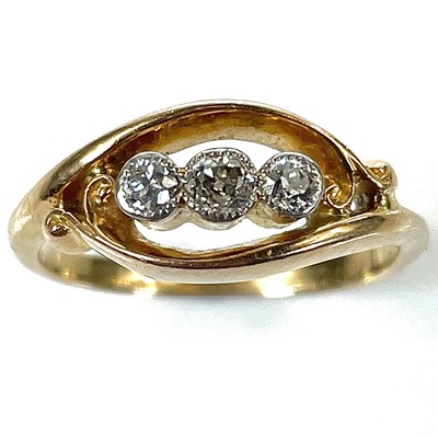 Lot 67 - An early 20th century 18ct gold three stone milgrain set diamond ring.