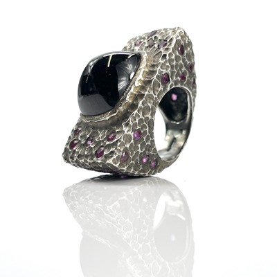 Lot 192 - A mid-century silver ruby and black stone set...