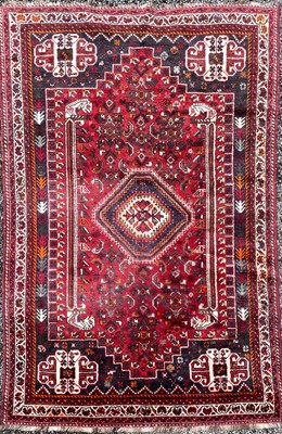 Lot 1231 - A Shiraz rug, South West Persia, the madder...
