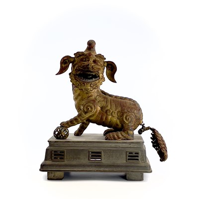 Lot 52 - A Chinese gilt metal model of a dog of fo,...