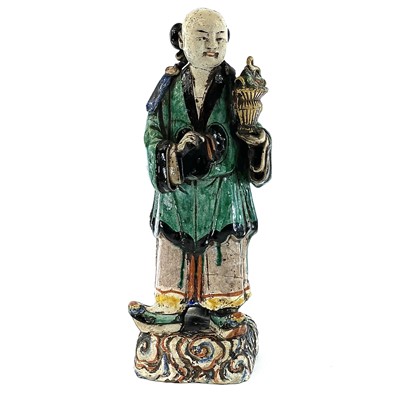 Lot 69 - A Chinese sancai-glazed standing figure,...