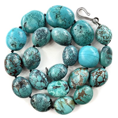 Lot 284 - A turquoise bead necklace with silver clasp,...