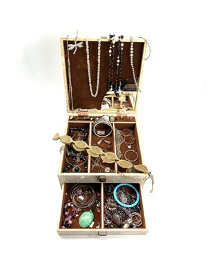 Lot 257 - A collection of costume jewellery in a musical...