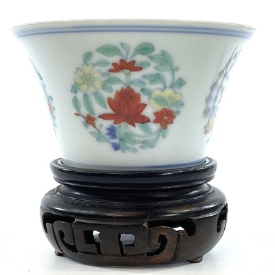 Lot 216 - A Chinese doucai porcelain cup, Qing Dynasty,...