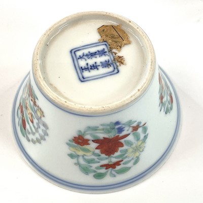 Lot 216 - A Chinese doucai porcelain cup, Qing Dynasty,...
