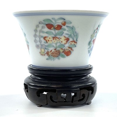 Lot 216 - A Chinese doucai porcelain cup, Qing Dynasty,...