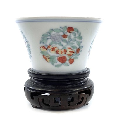 Lot 216 - A Chinese doucai porcelain cup, Qing Dynasty,...