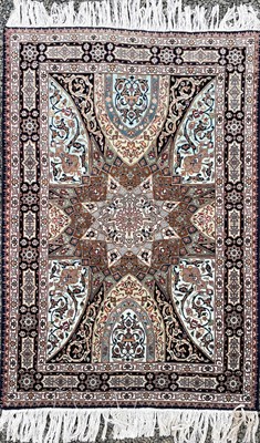 Lot 1247 - A Persian rug, the indigo field with a large...