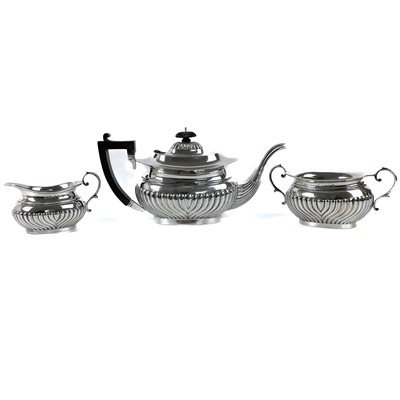 Lot 273 - An Edwardian silver half fluted three piece tea set.