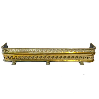Lot 30 - A Regency pierced brass fender.