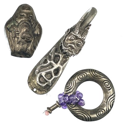 Lot 234 - A Chinese white metal dragon head belt hook, width 6.5cm, and two other Chinese white metal items.