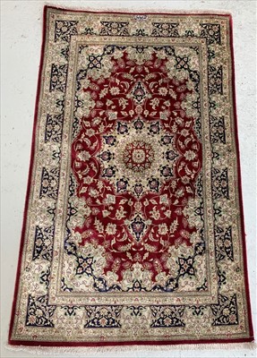 Lot 451 - A Qum silk rug, Central Persia, with cartouche...