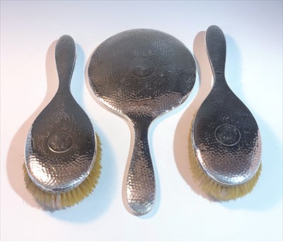 Lot 2072 - A pair of hammered silver hair brushes and a...