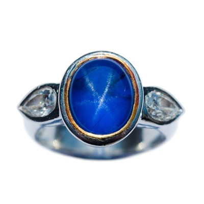 Lot 211 - A platinum set natural star sapphire and diamond ring.