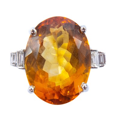 Lot 29 - An 18ct white gold citrine and diamond dress ring.