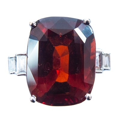 Lot 90 - An 18ct white gold garnet and diamond set dress ring.