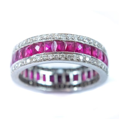Lot 75 - An 18ct white gold diamond and ruby set full eternity ring.