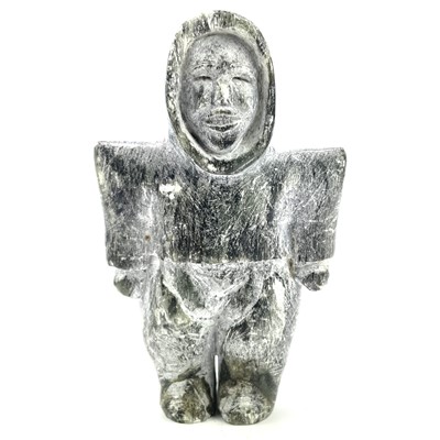 Lot 26 - An Inuit soapstone carving of a standing woman...