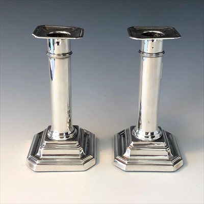 Lot 2069 - A pair of silver candlesticks.