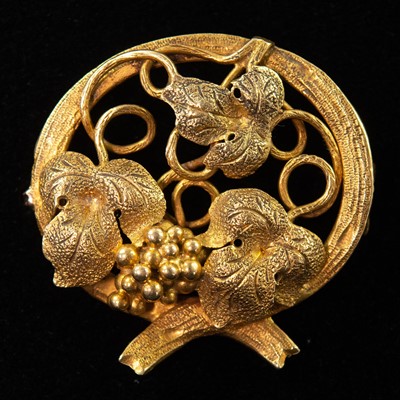 Lot 114 - A late 19th century gold fruiting vine openwork brooch.