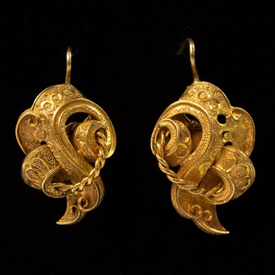Lot 102 - A pair of Victorian high purity gold scroll shaped openwork earrings.