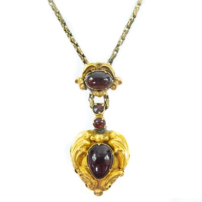 Lot 108 - A Victorian gold carbuncle garnet set heart shaped pendant locket and chain.
