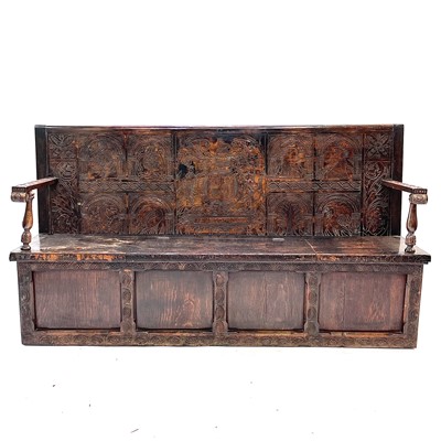 Lot 8 - A carved oak hall settle.