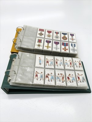 Lot 553 - Cigarette cards in two albums. 18 sets in...