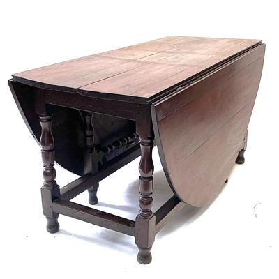 Lot 148 - A large oak gateleg dining table, 18th century.