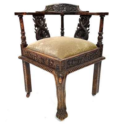 Lot 21 - A Victorian carved oak corner armchair.