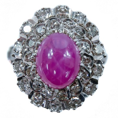 Lot 69 - A white gold star ruby and diamond set cluster ring.