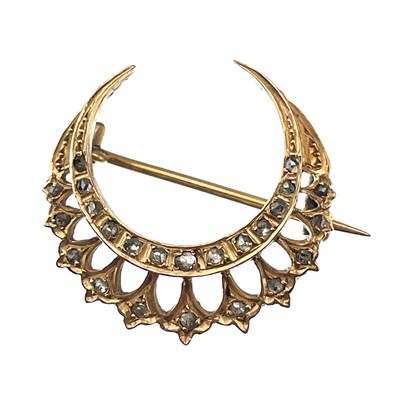 Lot 21 - A Victorian rose gold diamond set crescent brooch.