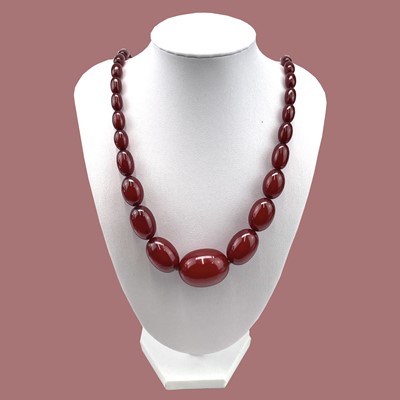Lot 237 - Cherry Amber Bakelite, with oval graduated beads.