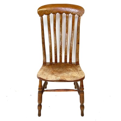 Lot 64 - A Victorian beech and elm lathe back kitchen chair.