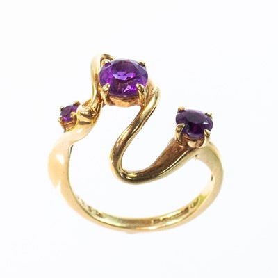 Lot 37 - A Bernard Instone 9ct amethyst set three stone ring.